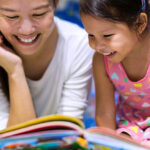 Parent and child reading books together