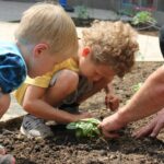 children planting in garden