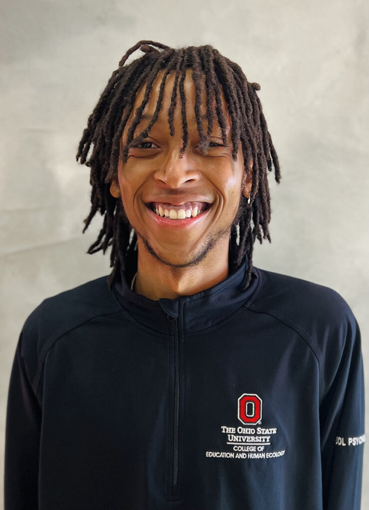 Headshot of Marcel Jacobs smiling at the camera while wearing a black OSU shirt. 