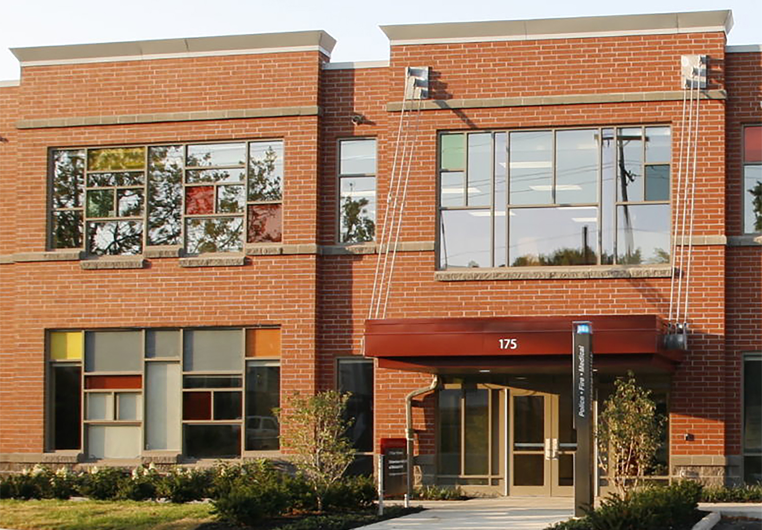 A section of a two-story, brick-fronted building with a red awning over the doors. The building is the Schoenbaum Family Center in Columbus, Ohio, home to Ohio State University's Crane Center for Early Childhood Research and Policy and the A. Sophie Rogers School for Early Learning.